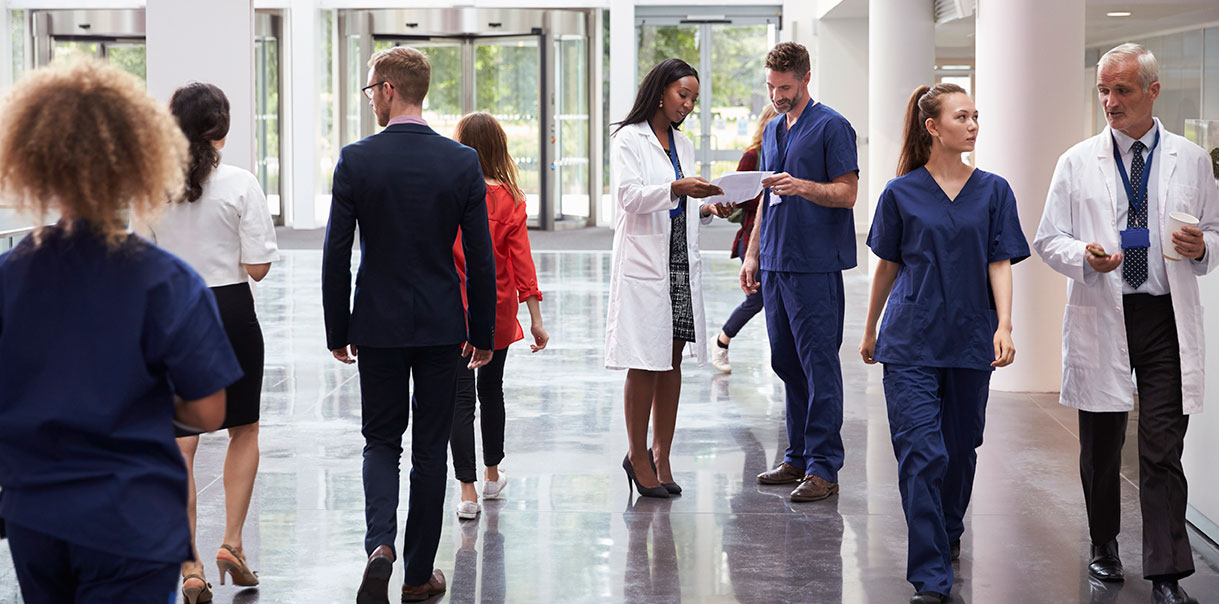 Image of a busy hospital lobby with doctors